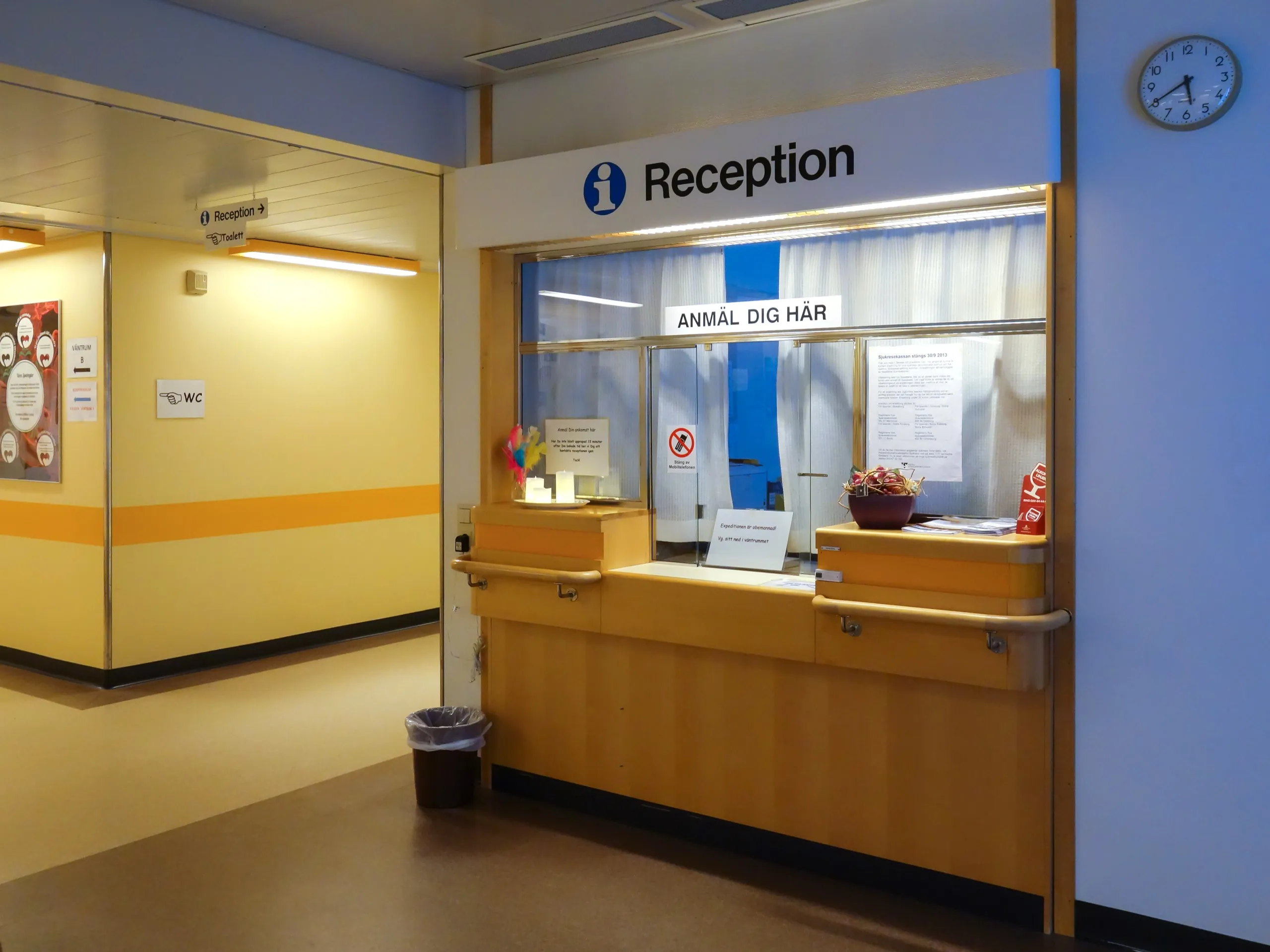 Reception desk of a hair and skin clinic with staff greeting a patient